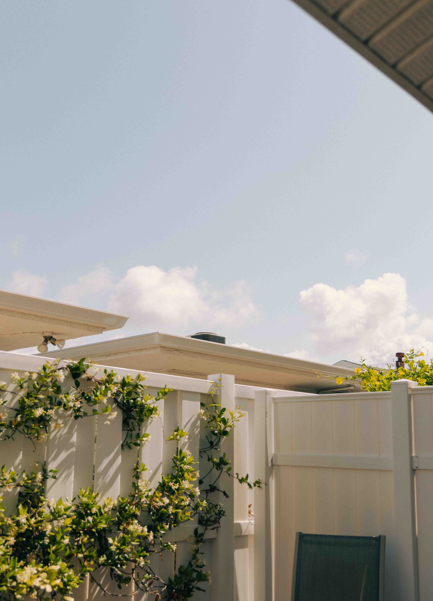White vinyl privacy fence in a residential backyard